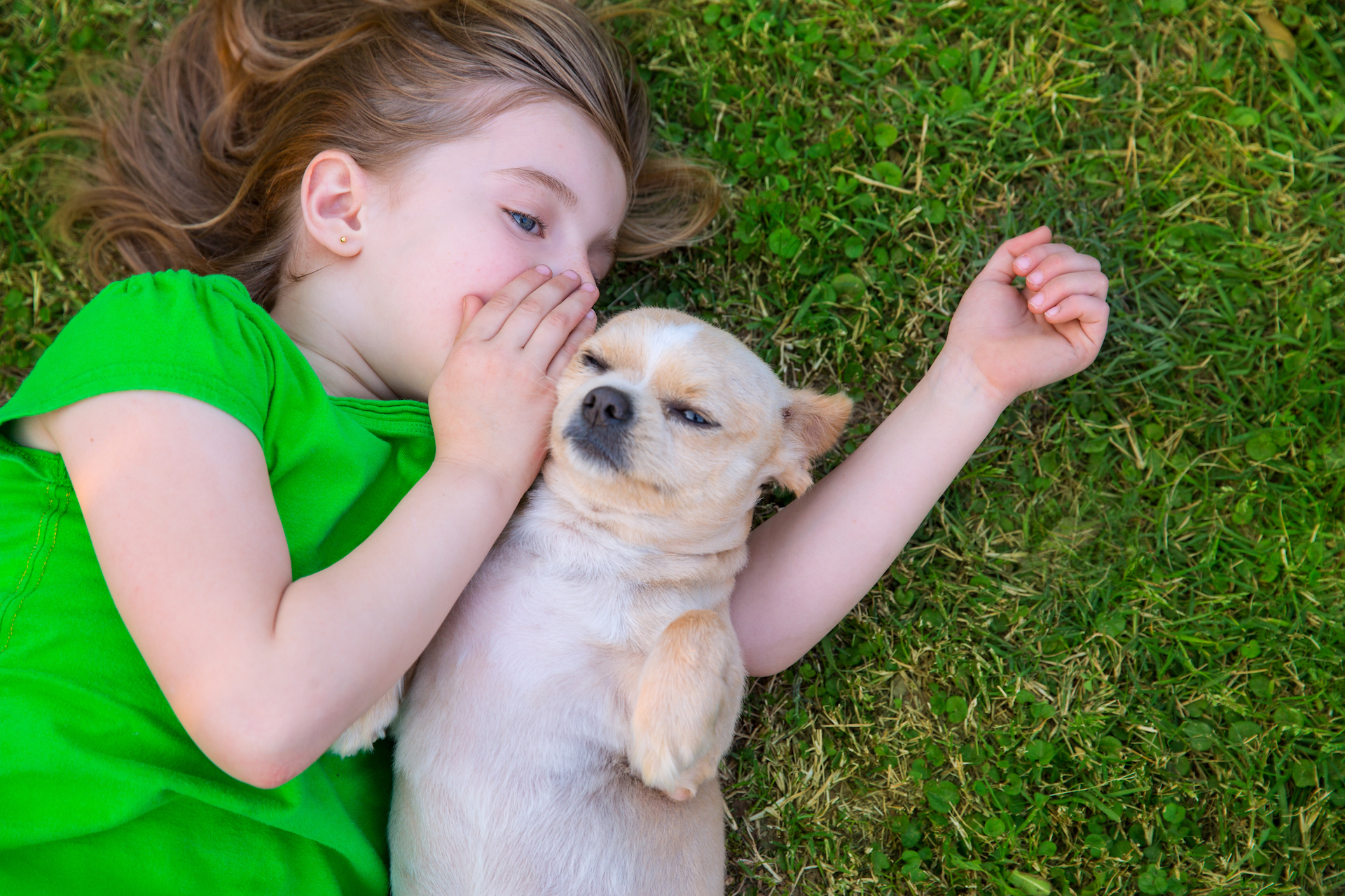 girl whispering to dog