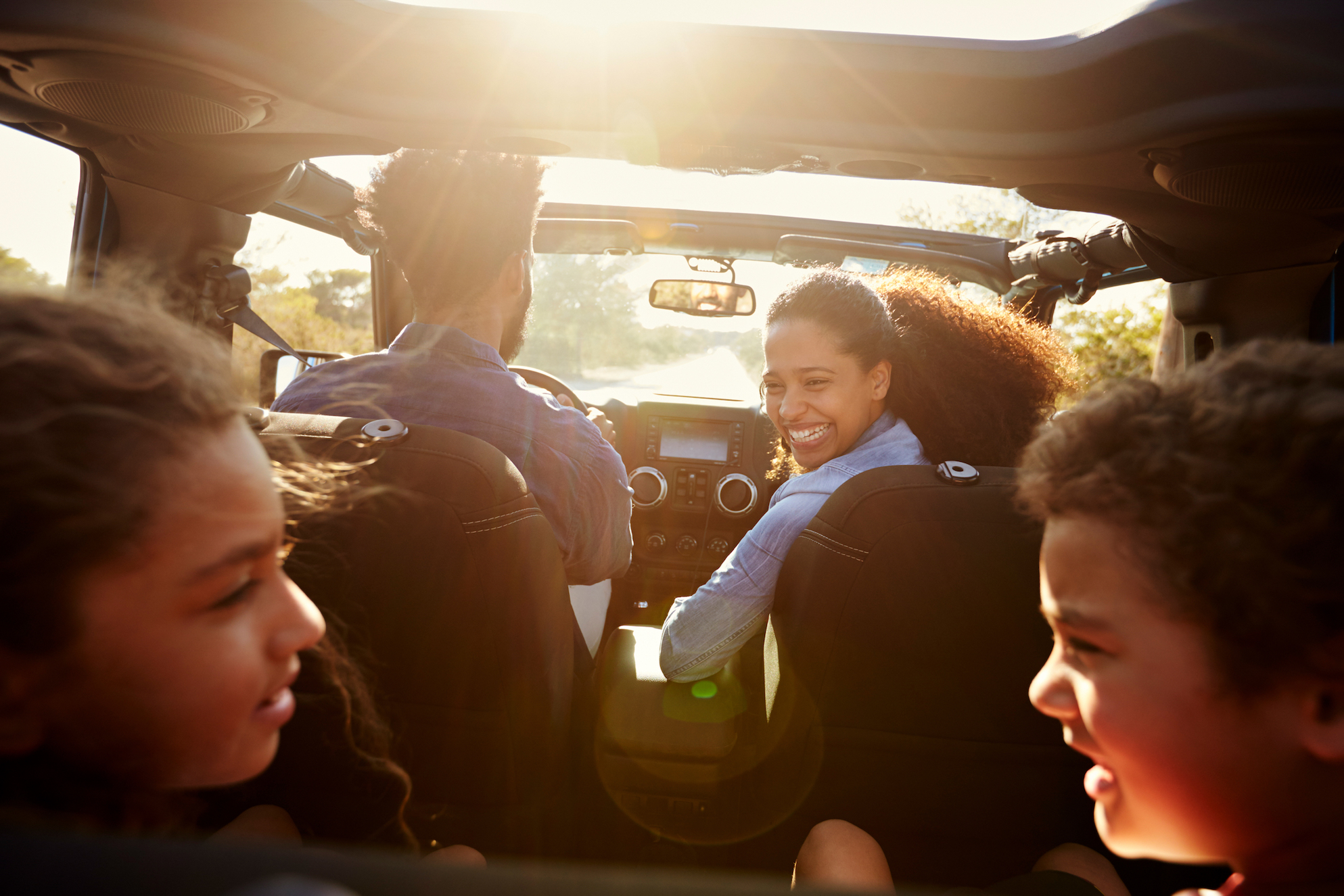 children with family in car